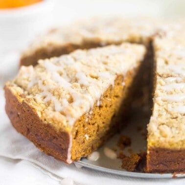Pumpkin Gingerbread Coffee Cake with a slice cut, ready to eat
