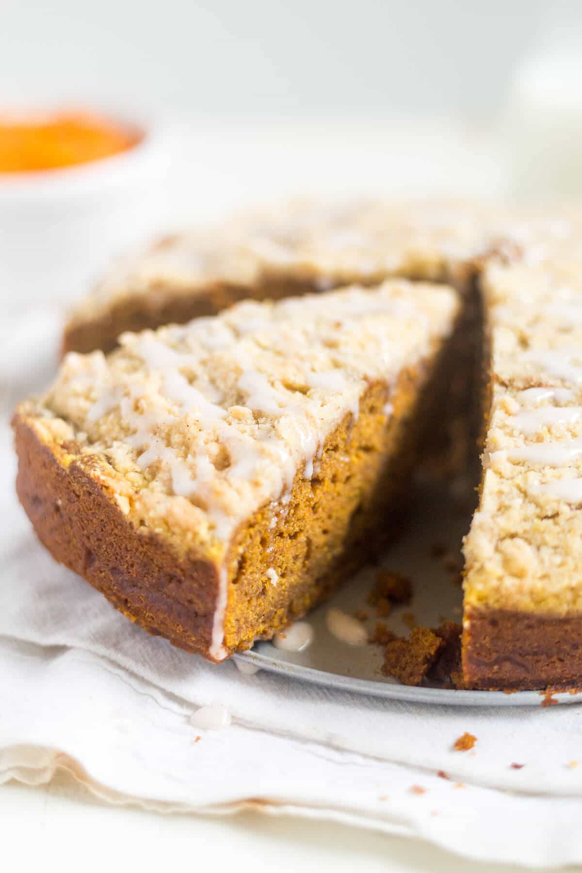 Pumpkin Gingerbread Coffee Cake with a slice cut, ready to eat