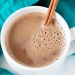 Caramelized Cinnamon Hot Chocolate served in a white ceramic mug with a cinnamon stick