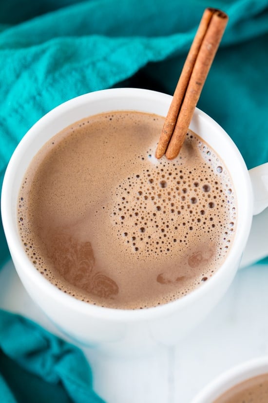 Caramelized Cinnamon Hot Chocolate in a mug with a cinnamon stick