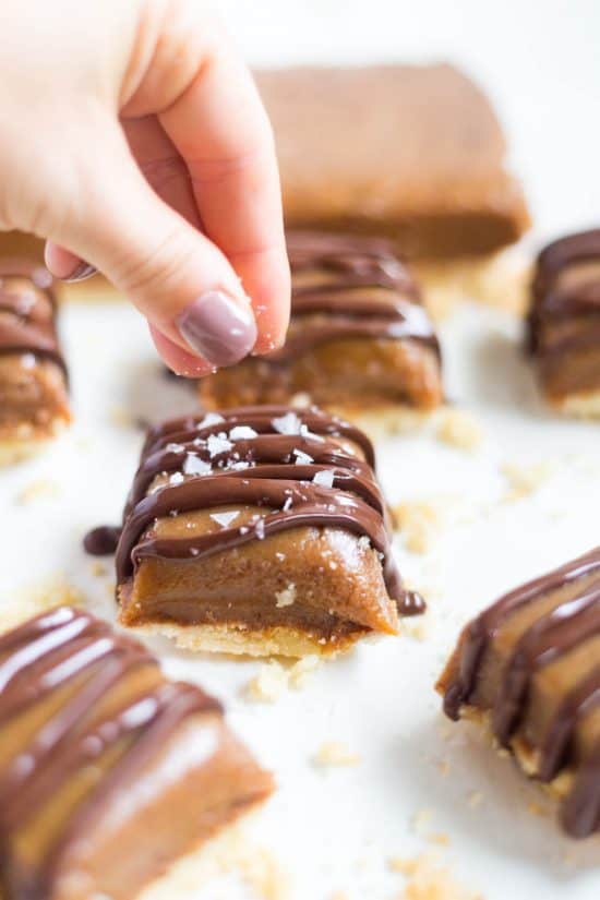 Rachel sprinkles sea salt on a Salted Caramel Shortbread Bar