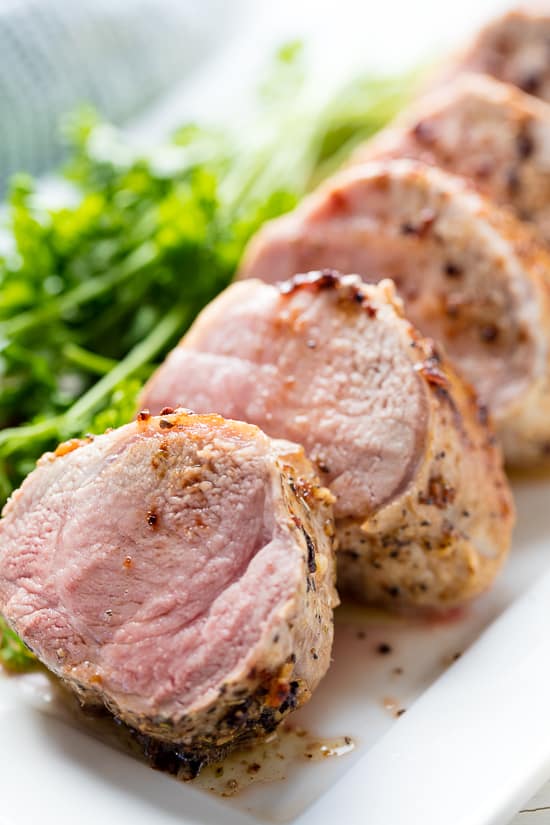 Pork tenderloin is seared and baked in a garlic butter sauce for a perfectly tender baked  Garlic Butter Pork Tenderloin