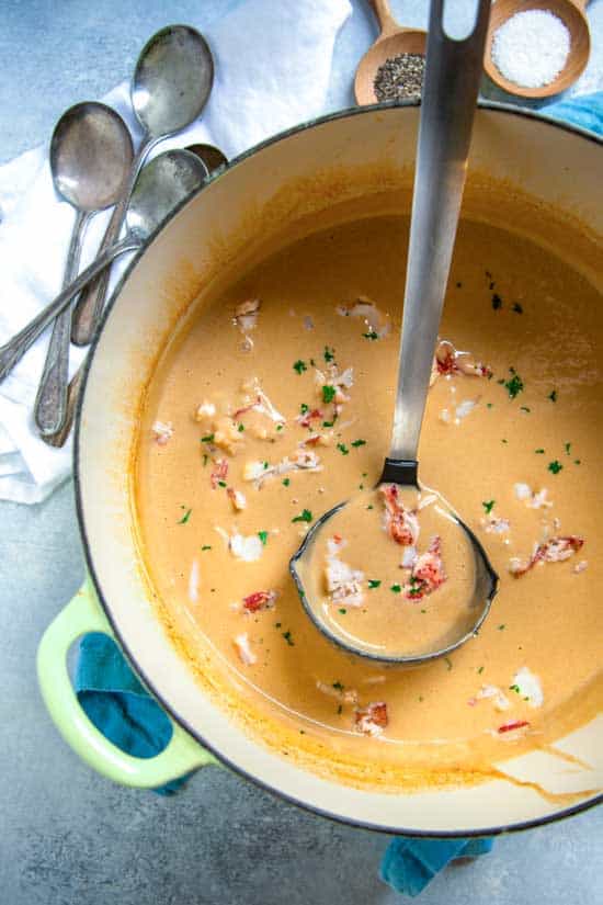 In this Restaurant Quality Lobster Bisque Soup you'll find chunks of sweet lobster meat in a beautifully rich, seasoned broth made from the strained liquid of the sautéed lobster shells, vegetables and herbs. Cream and sherry are added and the flavors are sublime.