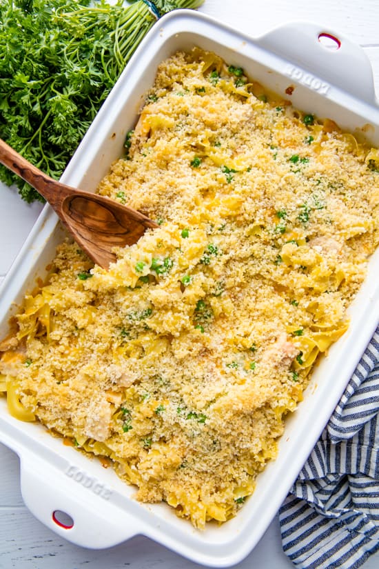 Tuna Casserole in a rectangular cooking dish with a wooden spoon in it.