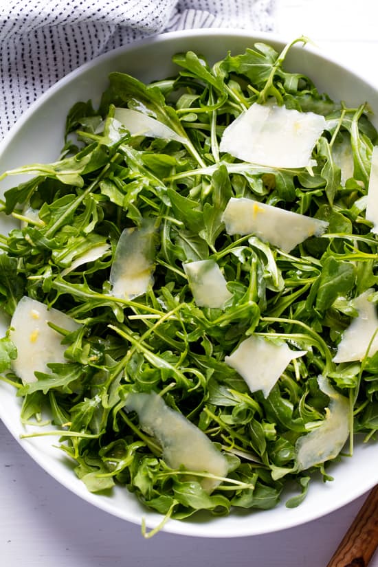Arugula Salad in a white bowl.