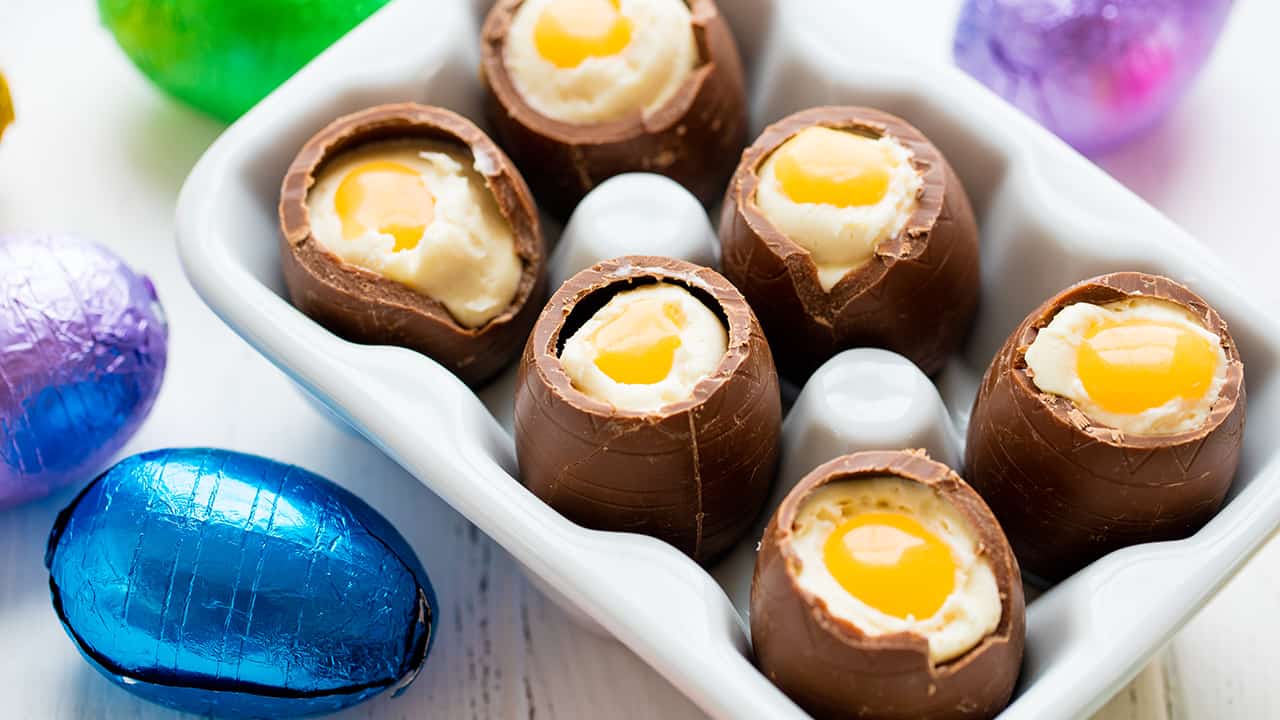 Several cheesecake filled chocolate easter eggs with their tops broken off