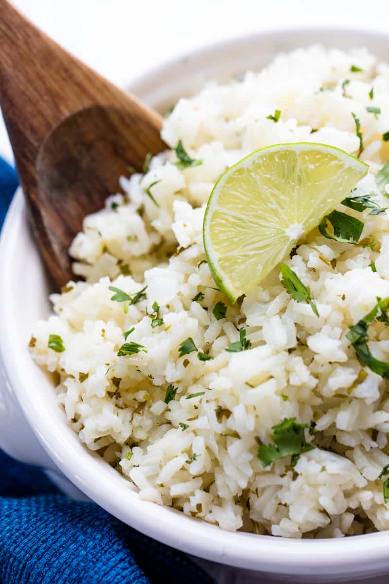 Cilantro Lime Rice topped with a lime slice in a white bowl.