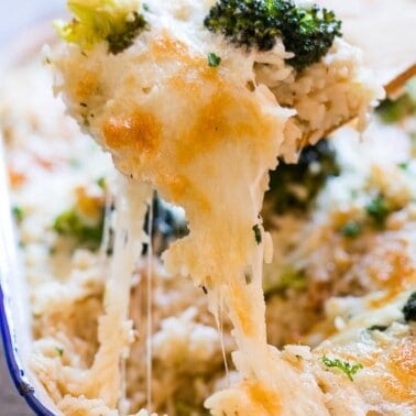 A spoonful of creamy broccoli rice casserole showing how cheesey it is