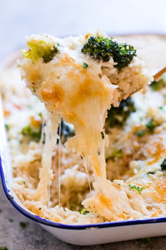 A scoop of Broccoli and Rice Casserole taken from its baking dish.