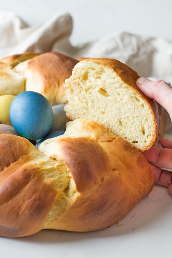 A slice of easter bread is taken from the loaf