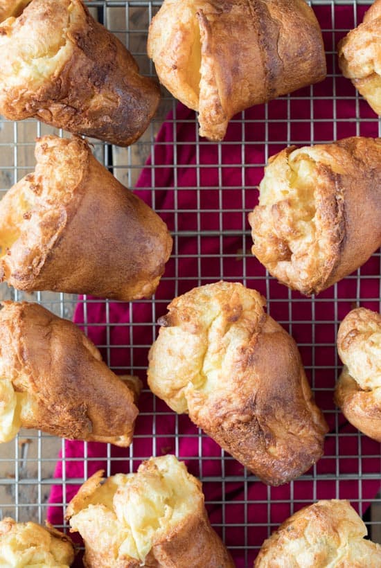 Popovers laying on a wire rack.