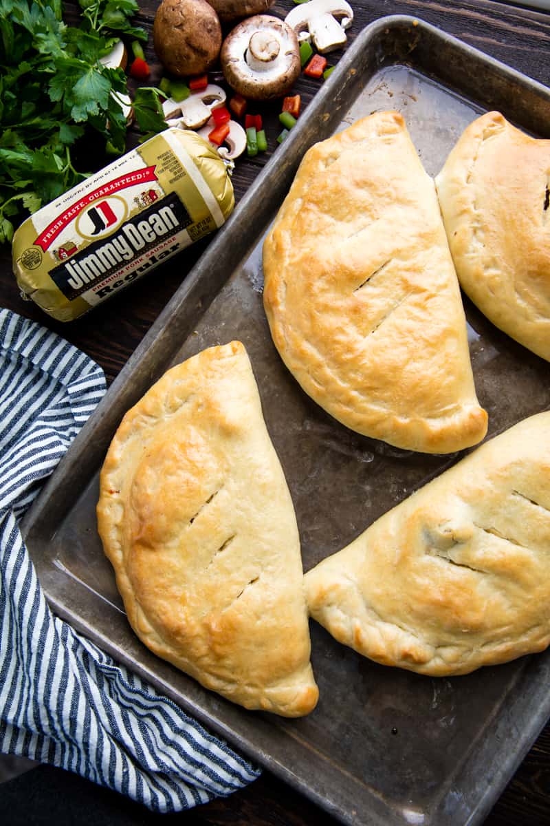 Bird's eye view of Calzones on a baking sheet. 