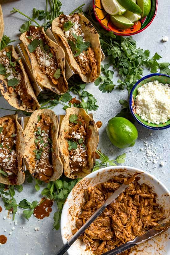 Birds eye view photo of finished Chicken Mole tacos and the ingredients needed to make them.