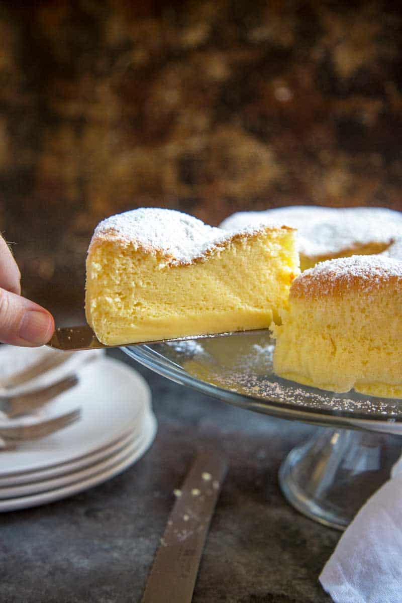 Japanese Cheesecake slice being removed from the rest of the cheesecake.