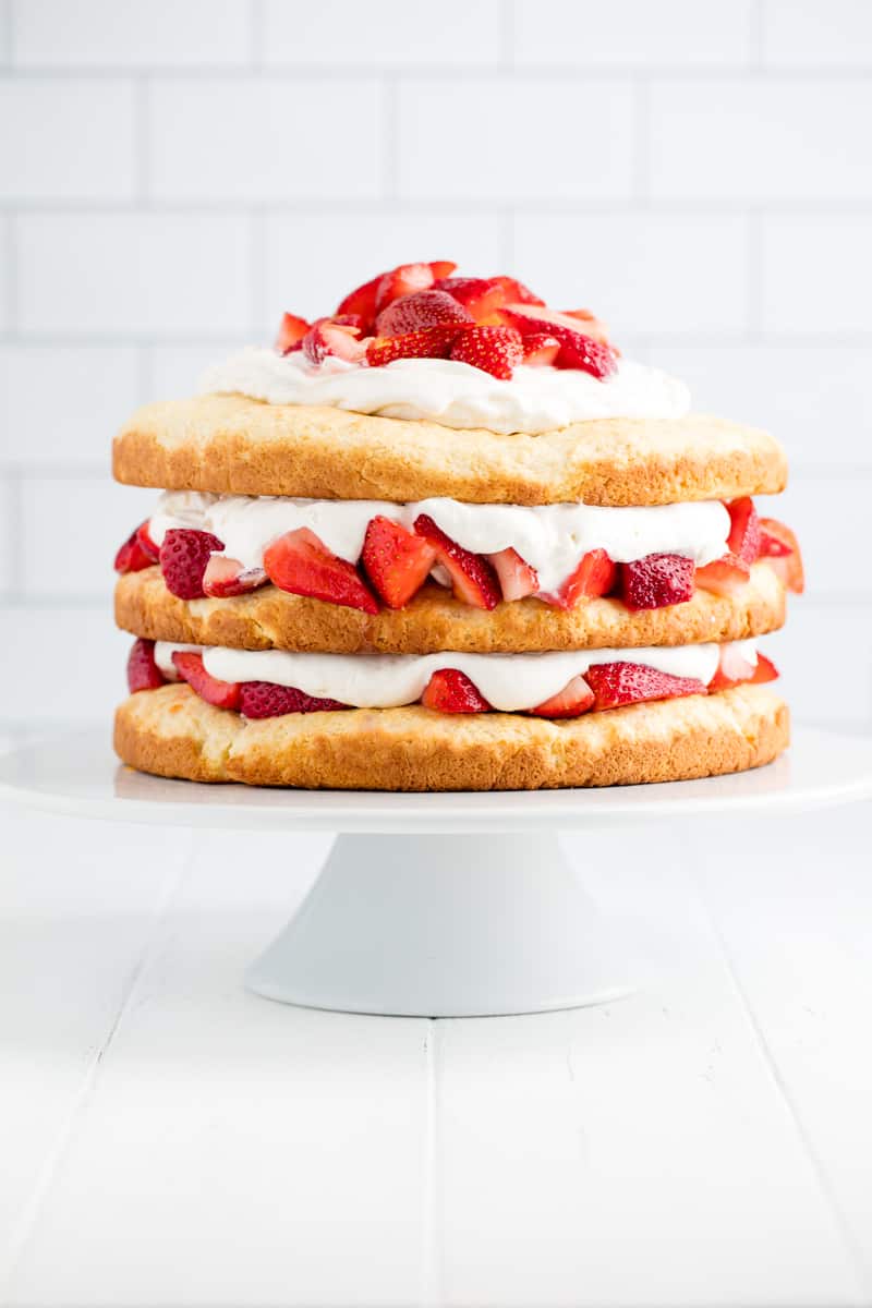 Strawberry Shortcake on a white cake stand.