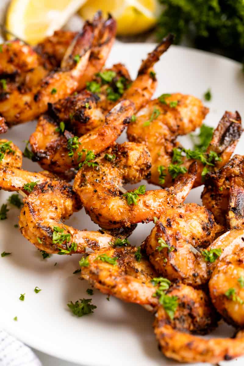 Grilled Shrimp on skewers on a white plate. 