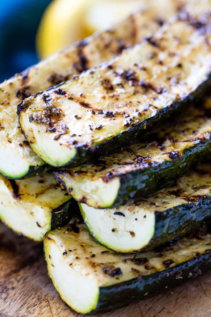 Close up of a stack of Grilled Zucchini on a cutting board.