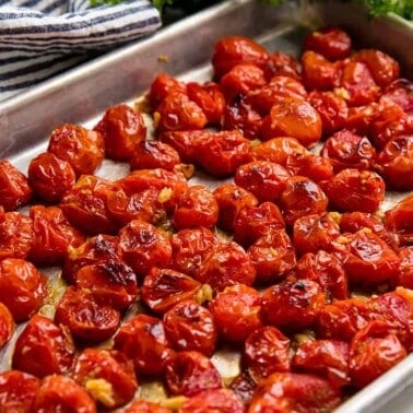 Roasted tomatoes on a baking sheet.