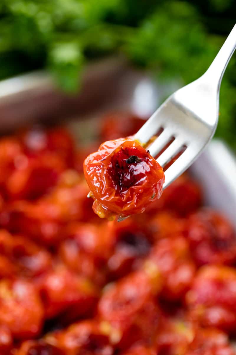 A fork holds up an oven roasted tomato