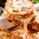 Slice of Eggplant Parmesan being pulled out of the pan by a spatula.