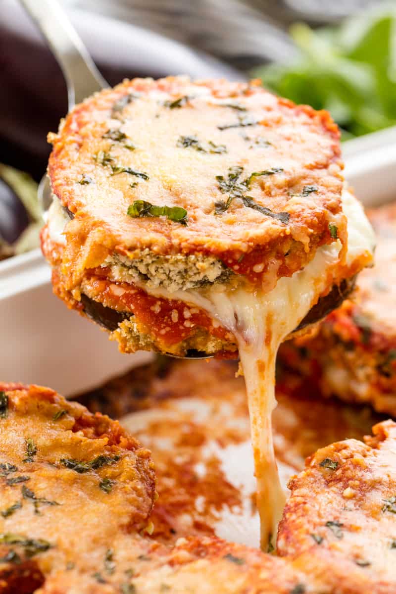 Slice of Eggplant Parmesan being pulled out of the pan by a spatula.