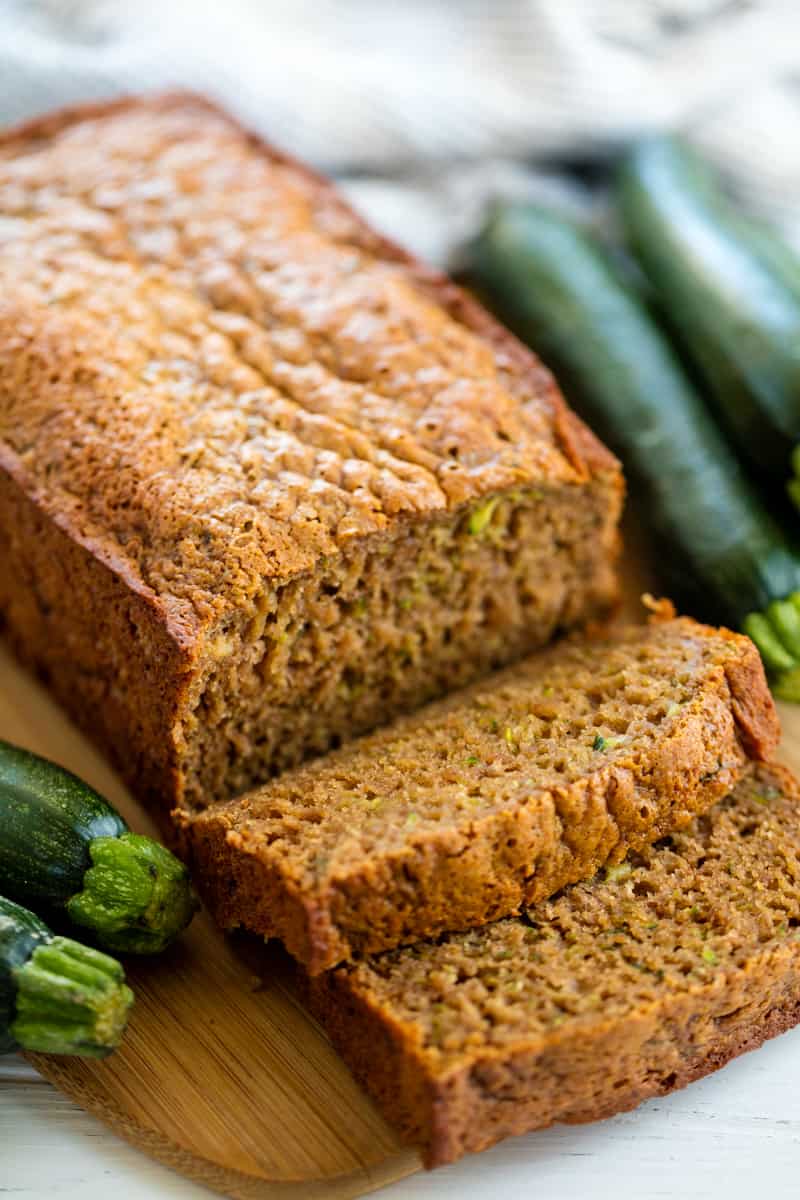 Zucchini Bread with two slices cut out and laying on each other on a cutting board.