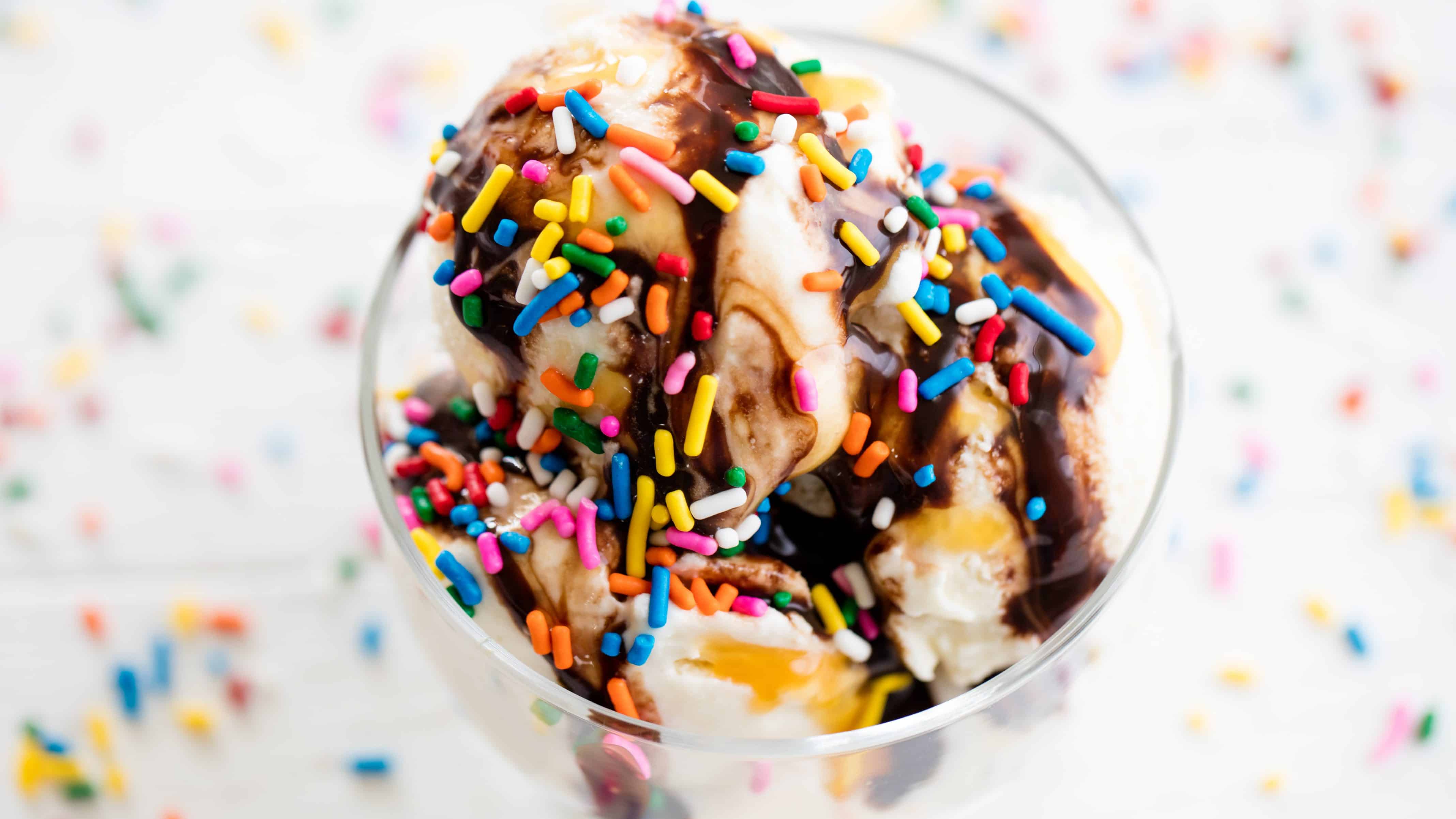 Homemade ice cream topped with chocolate syrup and sprinkles.