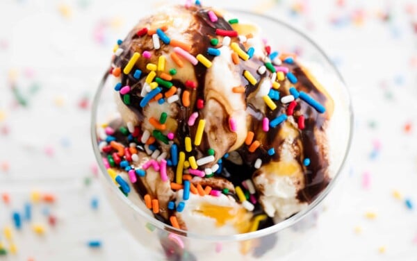 Homemade ice cream topped with chocolate syrup and sprinkles.