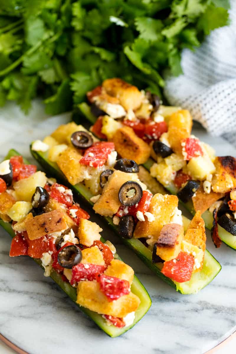 Stuffed Zucchini on a marble cutting board. 