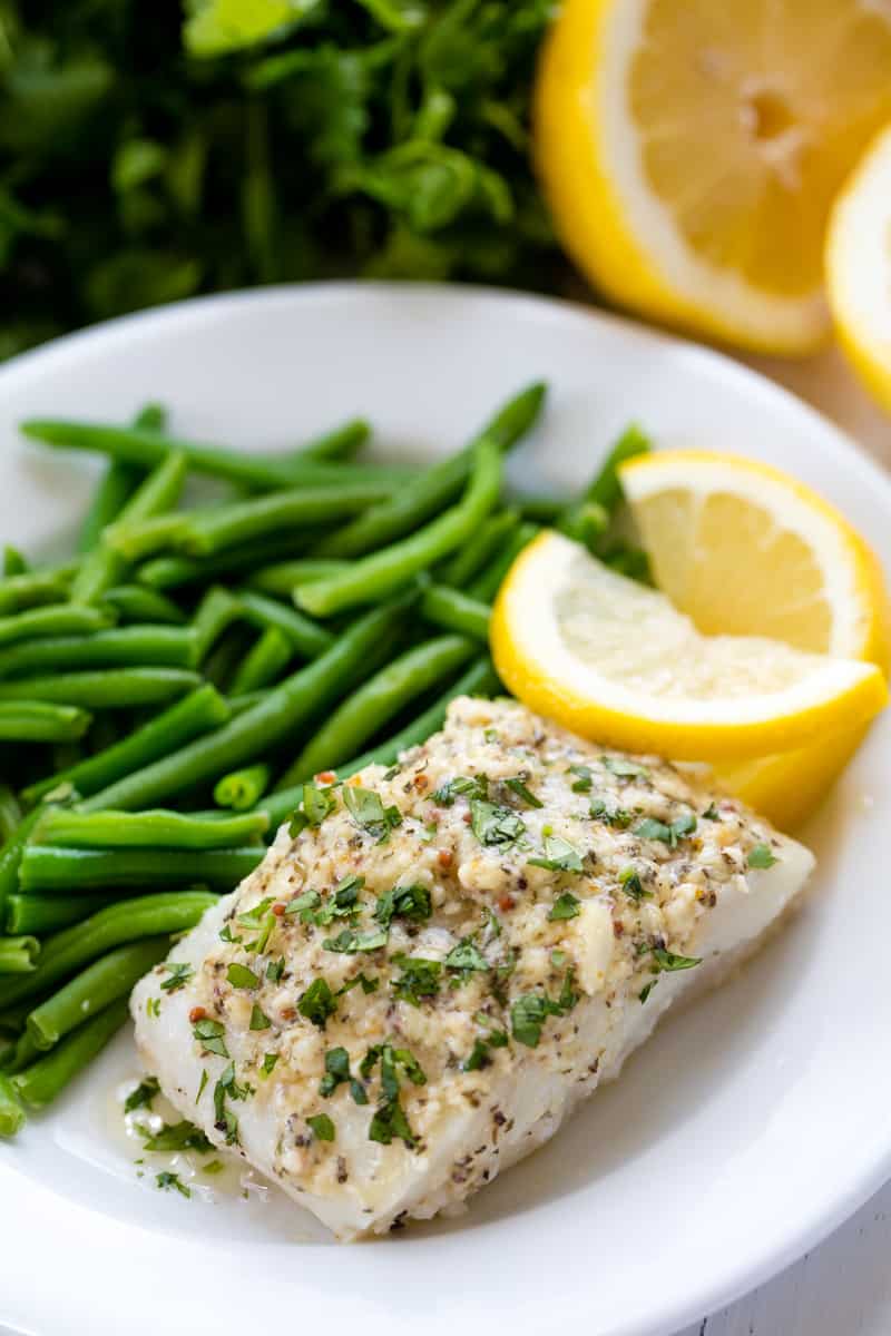 Easy Baked Cod Fish is smothered in a lemon garlic parmesan mixture that makes for a delic Easy Lemon Baked Cod Fish