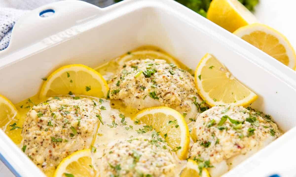 Close up of lemon baked codfish in a baking pan.