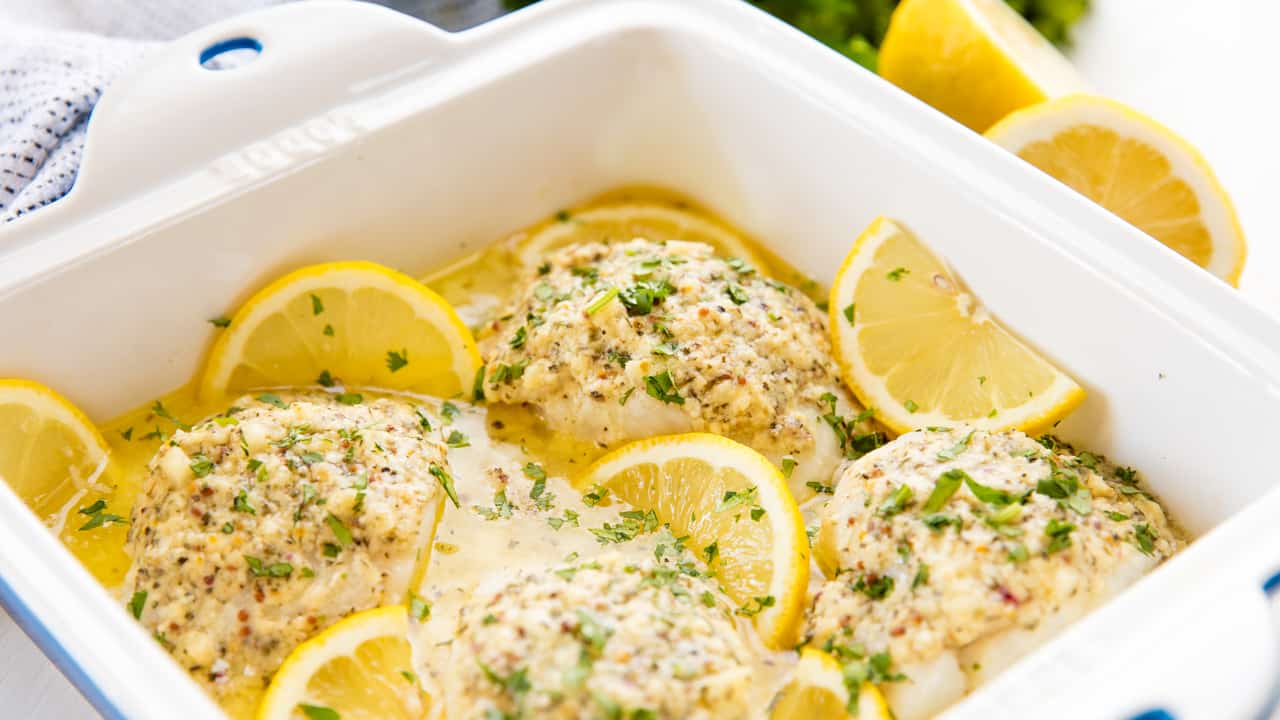 Close up of lemon baked codfish in a baking pan.