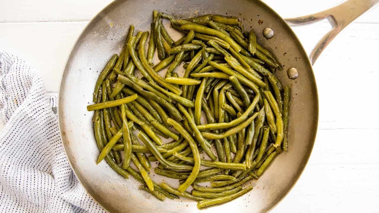 Bird's eye view of green beans in a skillet.