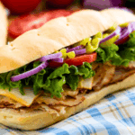 A loaded hoagie sandwich on a homemade hoagie roll.