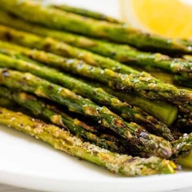 A stack of grilled asparagus on a platter