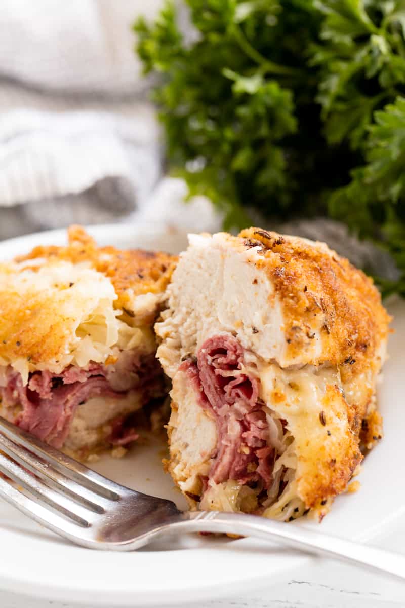 Stuffed Chicken cut in half to show the Reuben stuffing.