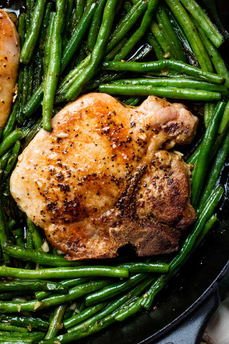 Skillet Garlic Butter Pork Chops are made in one pan with green beans for an easy dinner t Skillet Garlic Butter Pork Chops and Green Beans