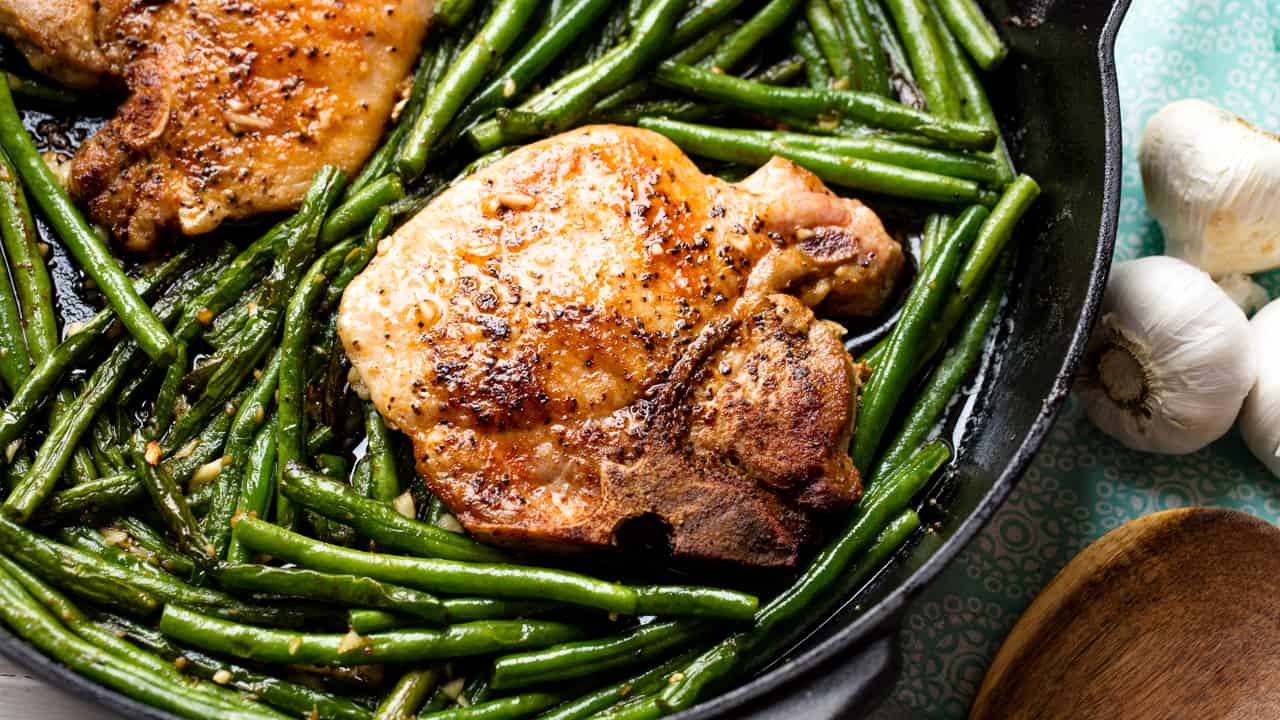 Skillet Garlic Butter Pork Chops are made in one pan with green beans for an easy dinner t Skillet Garlic Butter Pork Chops and Green Beans