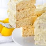A slice of Lemon Cake being removed from the rest of the cake.