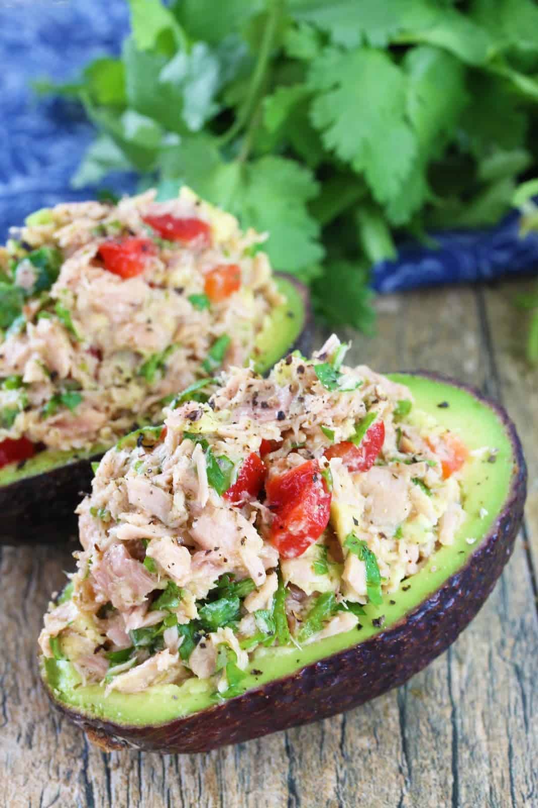 Tuna Stuffed Avocados on a wood countertop.