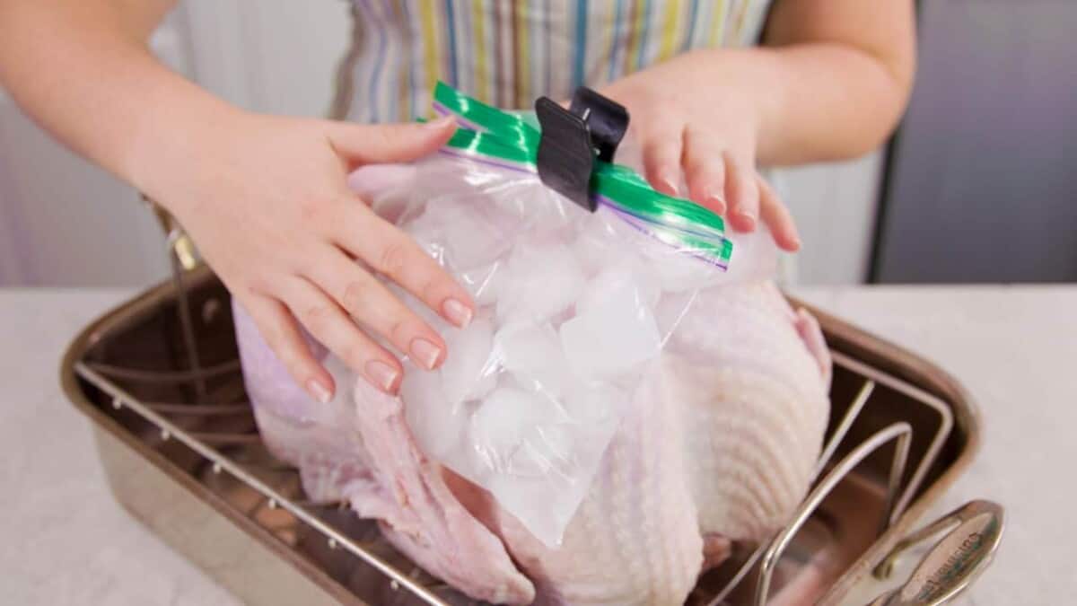 A visual demonstration of the ice pack trick for roasting turkey where the breasts are chilled using plastic bags of ice prior to roasting.