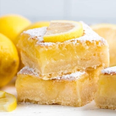 Stacked Lemon Bars with a lemon slice on top