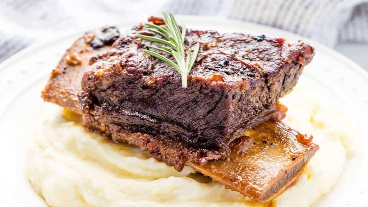 Close up of Beef Short Ribs on mashed potatoes.