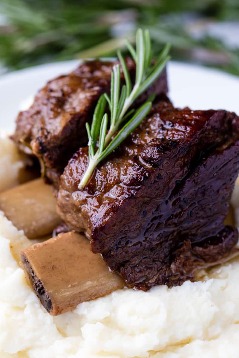 Close up of Beef Short Ribs on mashed potatoes.