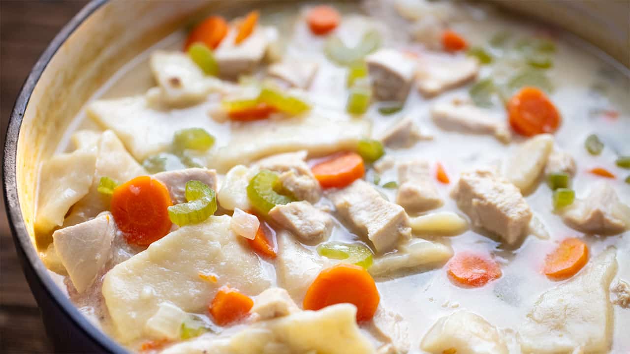 Close up view of the outer rim of Chicken and Dumplings in a ceramic pot.