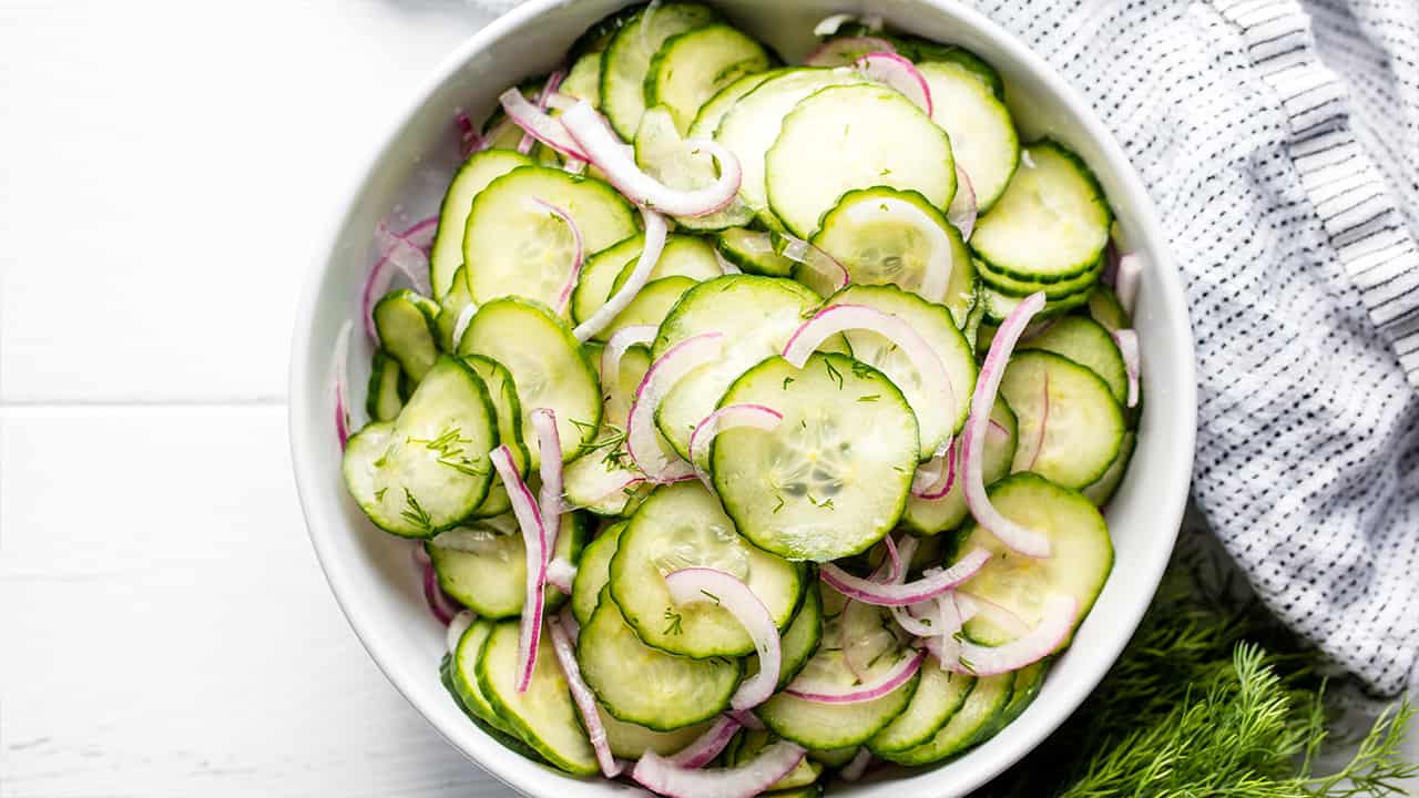 Bird's eye view of Cucumber Salad in a white bowl.