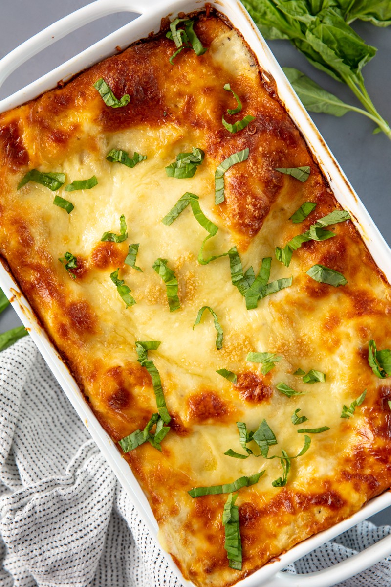 Bird's eye view of a Spinach Artichoke Lasagna in a baking dish.