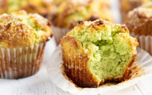 Close up of Pistachio Muffins one with a big bite out of it
