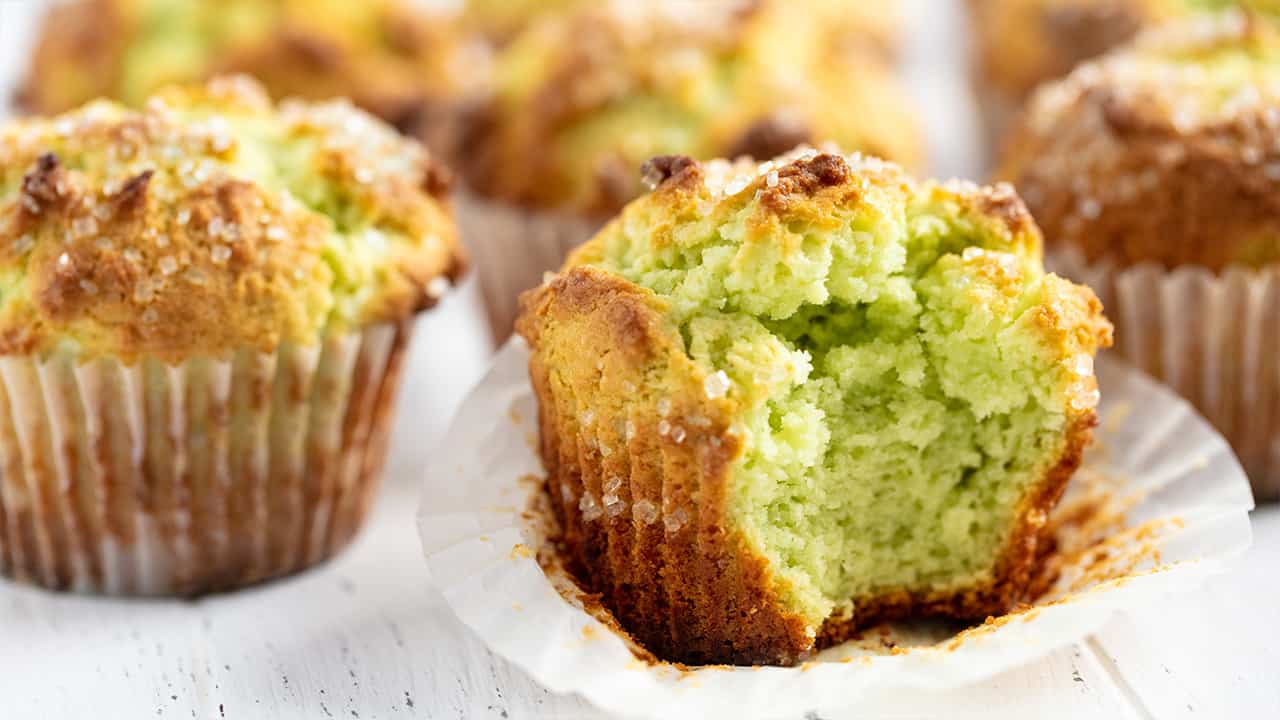 Close up of Pistachio Muffins one with a big bite out of it