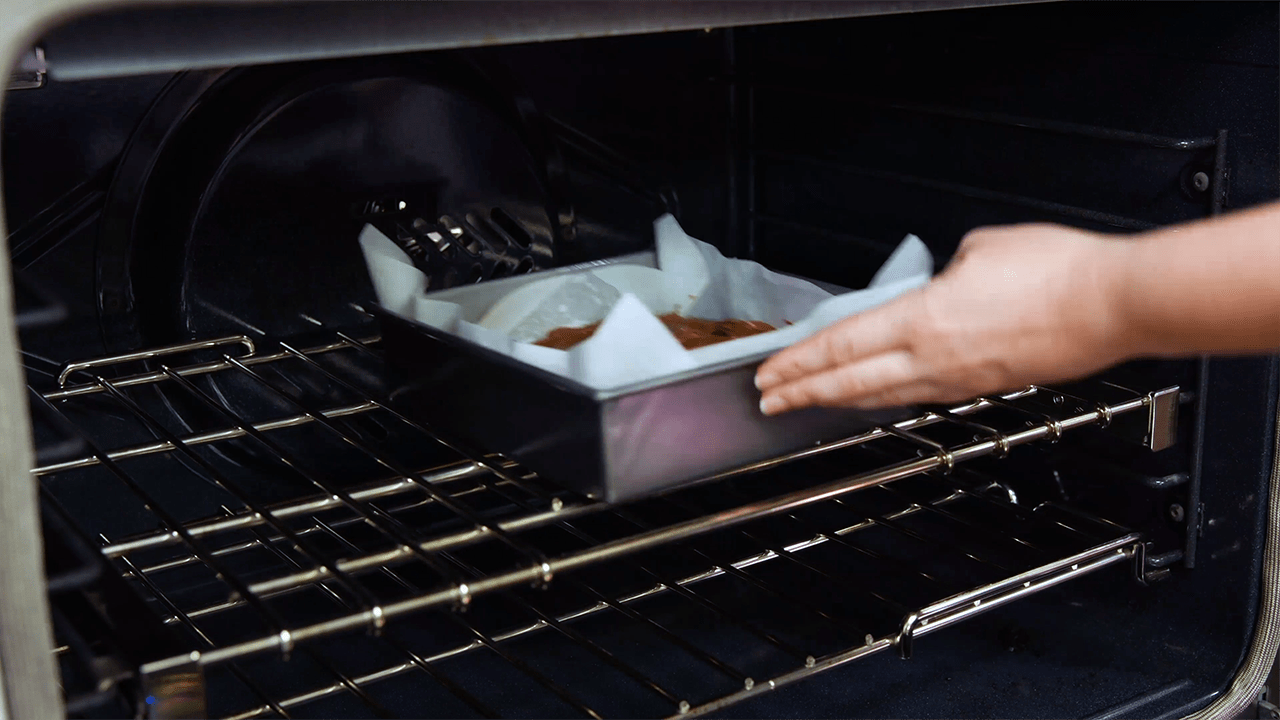 Pan of brownies being placed into an oven